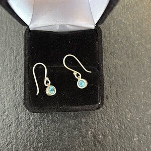 Sterling silver earrings with round blue topaz